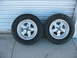 1997 Ford Crown Victoria - A pair of aftermarket wheels and tires are displayed against a neutral background.