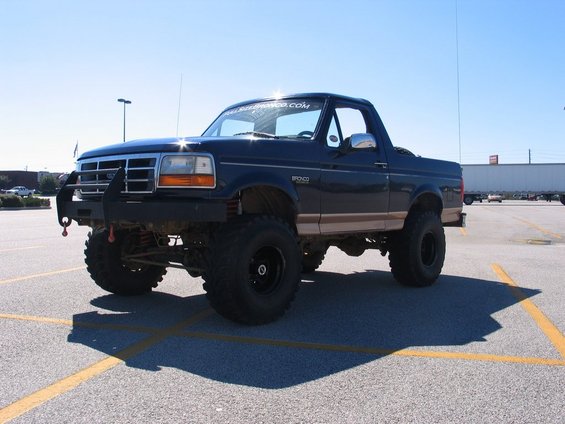 Dark blue 1995 Ford Bronco with tan trim and aftermarket bumper