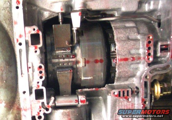 Transmission internals with red fluid residue and metal components
