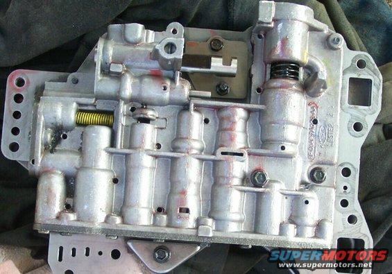 Automatic transmission valve body with visible springs and solenoids. Ford part number visible