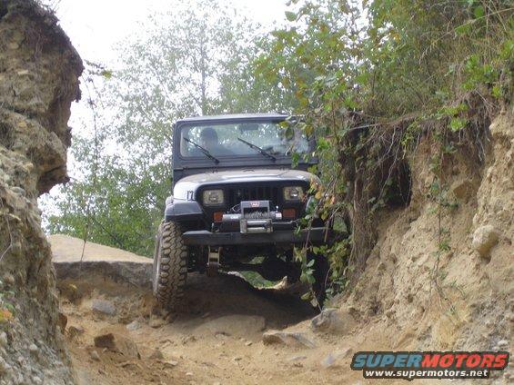 Black Jeep Wrangler with winch on rocky trail