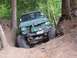 1990 Ford Bronco - This off-road vehicle navigates a challenging dirt path, its capabilities.