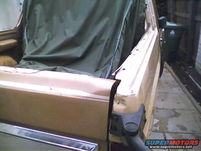 1994 Ford Bronco, tan, side view, soft top removed, showing interior and rear quarter panel