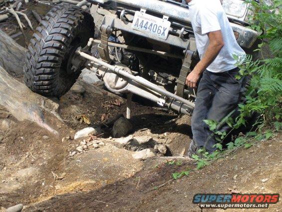Front view of off-road vehicle with Washington license plate A44406X on rocky terrain