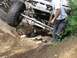 1990 Ford Bronco - A vehicle with a Washington license plate navigates a challenging rocky trail, demonstrating its off-road capabilities.