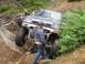 1990 Ford Bronco - Off-road vehicle attempts to navigate a difficult obstacle on a trail.