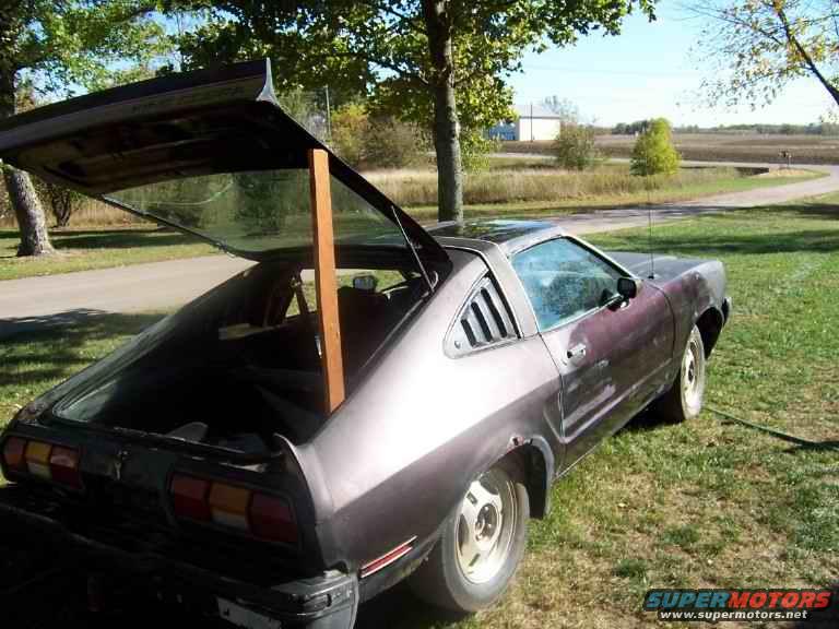 1978 Ford Mustang II hatchback with open rear hatch, parked on grass