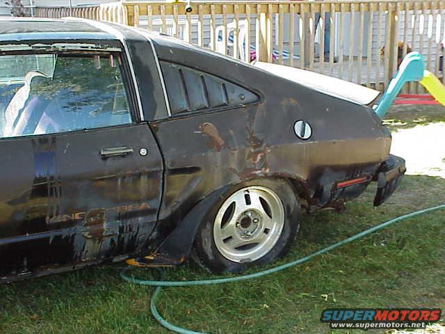 Side view of a black 1978 Ford Mustang II hatchback with louvers