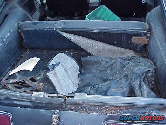 1978 Ford Mustang II trunk interior showing carpet, a green plastic bin, and other items