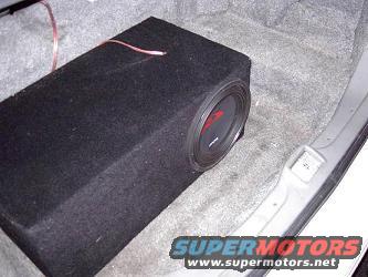 Car subwoofer box in trunk, looks like an aftermarket install