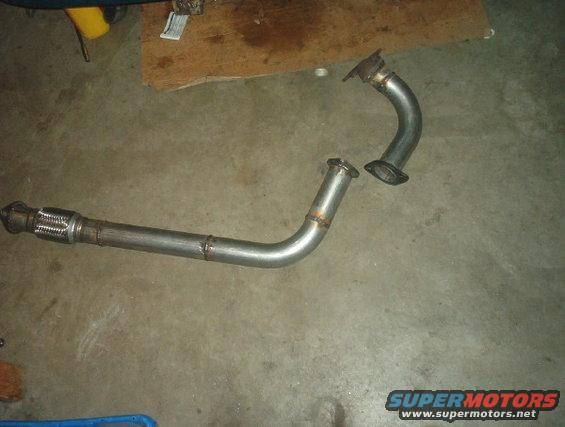 Two sections of a car exhaust pipe, one with a flexible metal joint