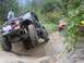 1990 Ford Bronco - Two off-road vehicles tackle a challenging rocky trail, with the lead vehicle demonstrating impressive articulation.
