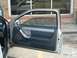 1994 Ford Thunderbird - The interior door panel of a car is visible with the door open.