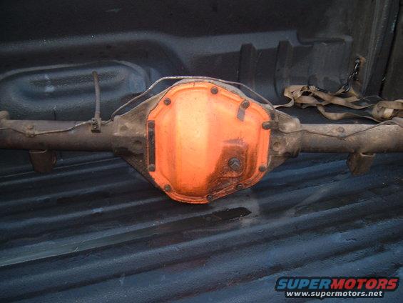 Rear axle differential with orange cover, sitting in truck bed