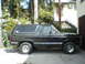 1981 Ford Bronco - Side view of a black Ford Bronco with a spare tire on the rear.