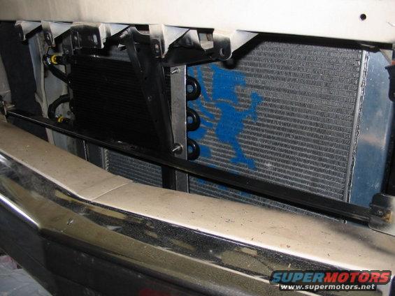 Engine oil cooler mounted in front of a radiator with a blue spray-painted figure