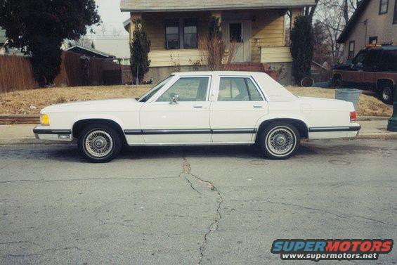 1991 Mercury Grand Marquis sedan, side view, parked on street