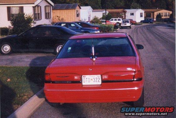 Red 1992 Ford Thunderbird parked on street, black Ford Thunderbird in background