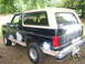 1988 Ford Bronco - This Ford Bronco shows signs of body repair and is viewed from the rear three-quarter angle.