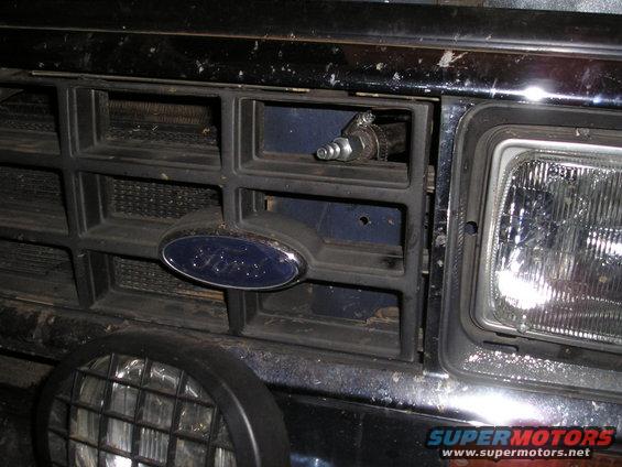 1986 Ford Bronco II grille with a Ford emblem and an air fitting installed in one of the grille openings