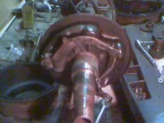 Vehicle brake assembly with drum and suspension components visible