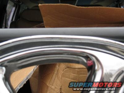 Chrome wheel with cardboard boxes inside a vehicle