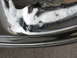 1999 Mitsubishi 3000GT - Chrome wheel rim detail, showing wear and tear. Supermotors.net logo visible.