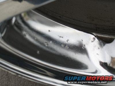 Chrome wheel showing pitting and damage. Supermotors.net logo visible