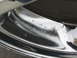 1999 Mitsubishi 3000GT - Close-up of a damaged chrome wheel with visible pitting and corrosion.