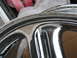 1999 Mitsubishi 3000GT - Close-up of a chrome wheel rim with a black stripe, possibly for a car.