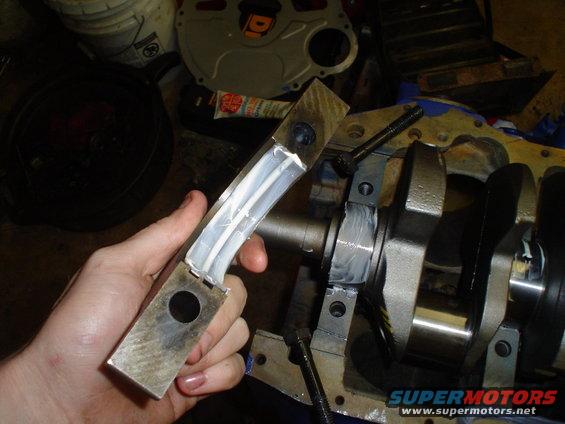 Engine crankshaft with bearing caps being installed