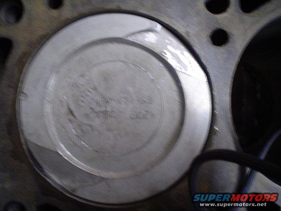 Piston inside engine block with visible markings