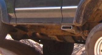 side-exhaust-1.jpg you can see a bit of the skidplate here. it's the only thing with black paint under the truck. this is the unmodified side.