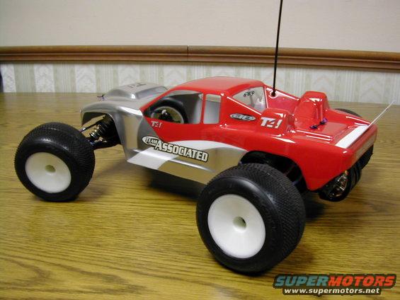 Red and silver remote control monster truck with 'TEAM ASSOCIATED' visible