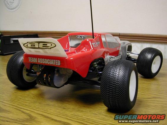 Red remote control buggy with white wing that says 'TEAM ASSOCIATED'