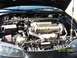 1997 Mitsubishi Eclipse - The engine bay of a Mitsubishi vehicle, the DOHC 16 valve engine and an aftermarket air intake system.