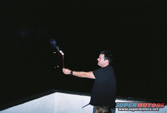 Man holding a sparkler at night