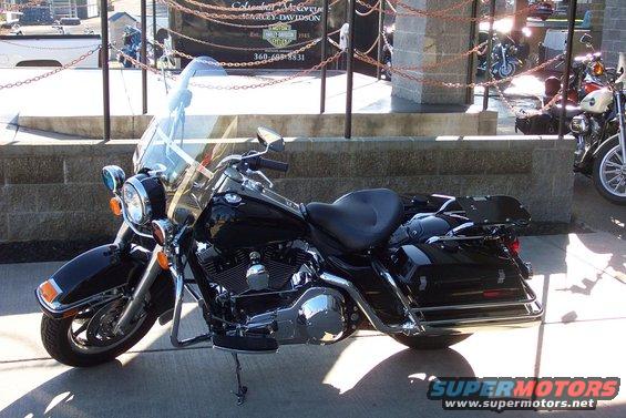 Black Harley-Davidson motorcycle parked outside a dealership