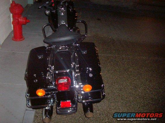 Black 2005 Harley-Davidson FLH motorcycle rear view, with saddlebags and chrome accents