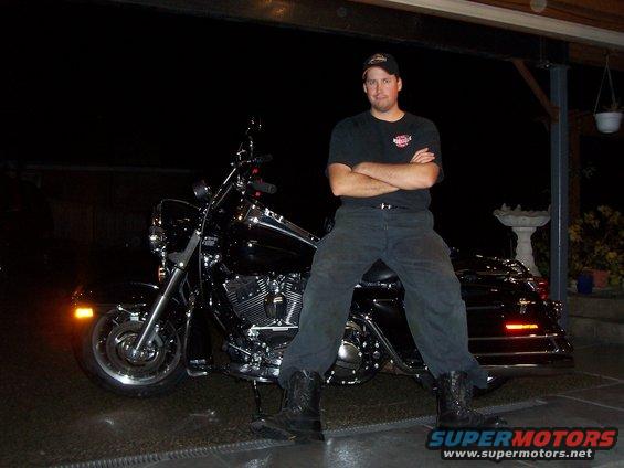 Black Harley-Davidson motorcycle with a man sitting on it
