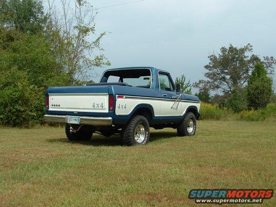 Rear view of a blue and white 1979 Ford Bronco with 4x4 badging