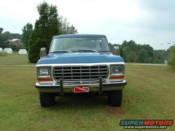 Front view of a blue 1979 Ford Bronco parked on grass