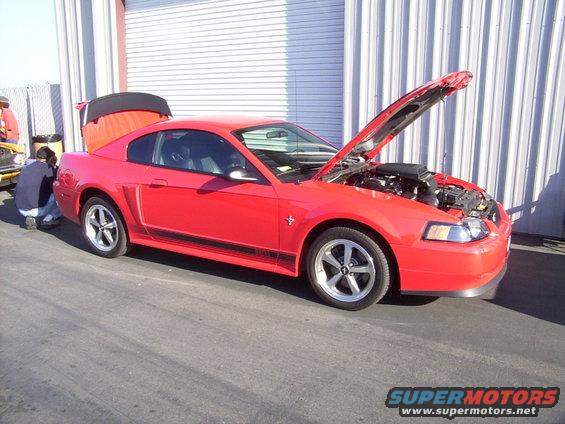 Red 2002 Ford Mustang with hood and trunk open