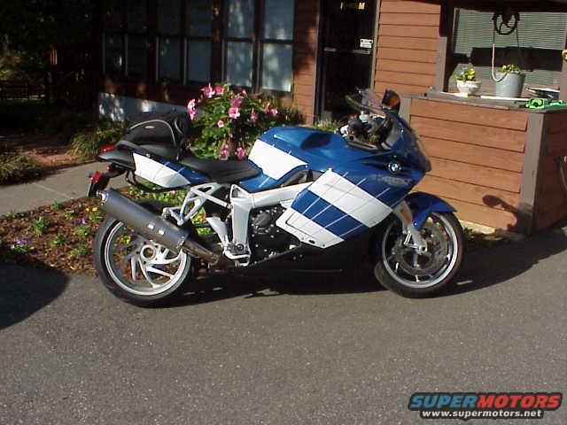 Blue and white motorcycle parked on asphalt