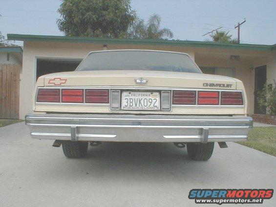 Rear view of a tan Chevrolet Caprice parked in a driveway. License plate reads 3BVK092