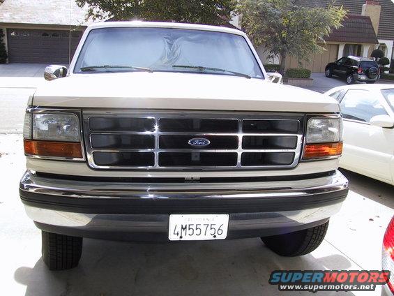 Tan 1992 Ford F-250 front view with chrome grille and Ford emblem