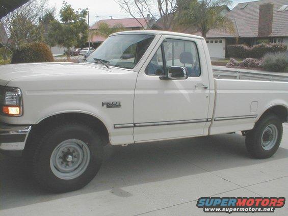 White 1992 Ford F-250 pickup truck, side view, showing F-250 badge on fender