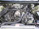 1997 Ford Thunderbird - Close-up view of a car's engine bay, showing various mechanical parts and wiring.