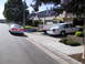 1997 Ford Thunderbird - Two white sedans and a white pickup truck are parked in a suburban driveway and on the street.