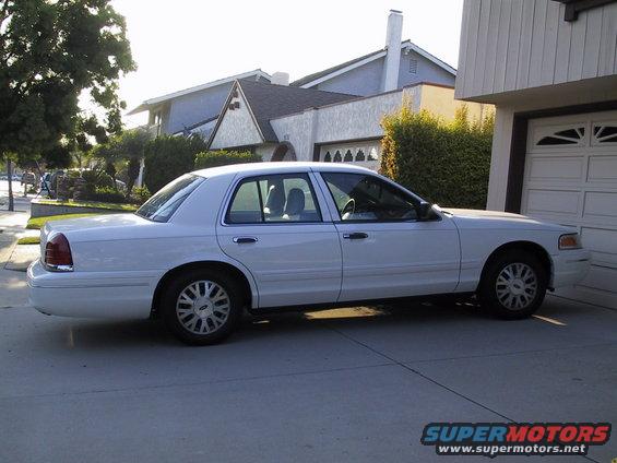 White 2003 Ford Crown Victoria parked in a driveway, side view